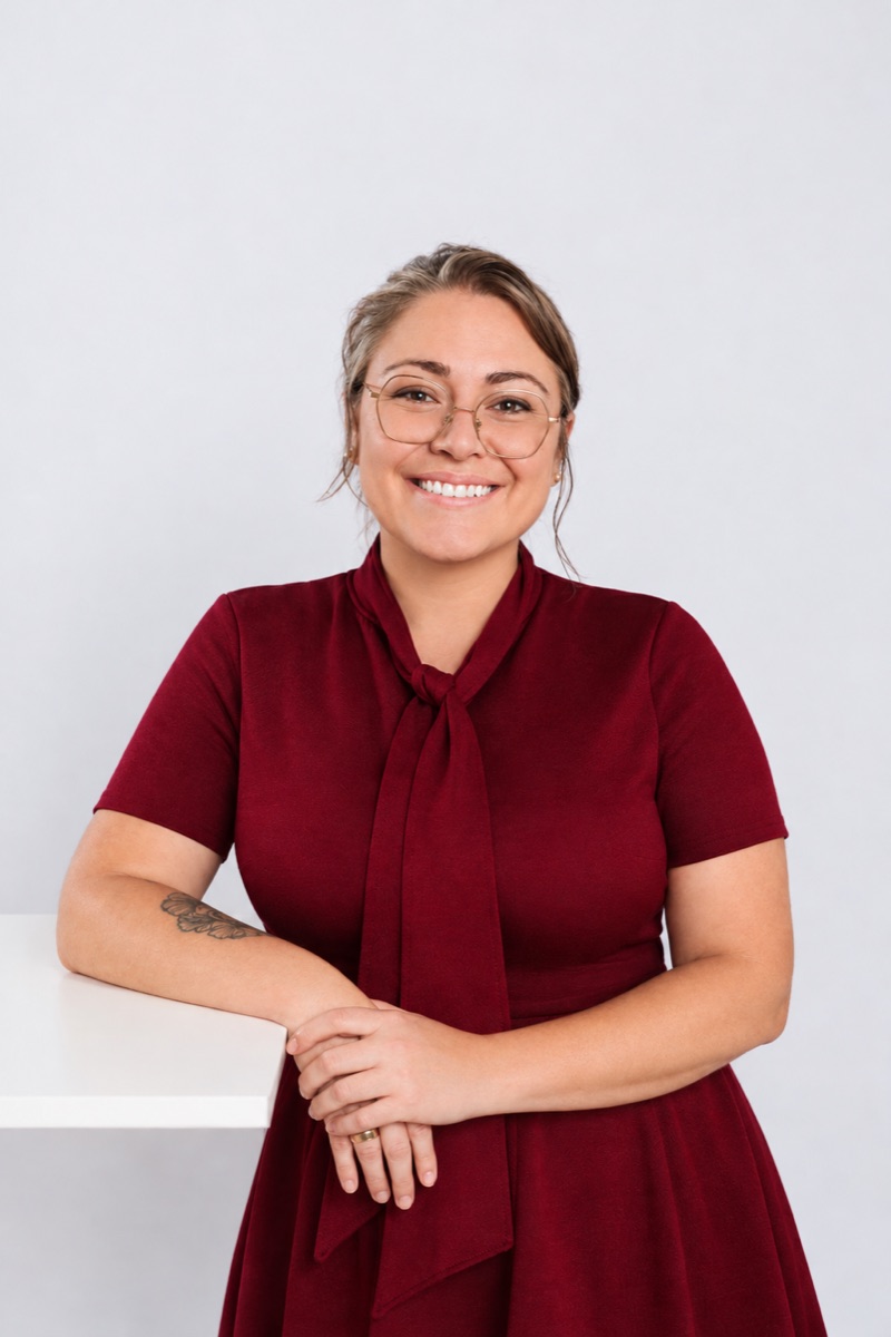 Emily Butterfield, smiling, in a burgundy dress